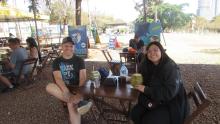 Eduardo and Ceci sitting at a picnic table, smiling.