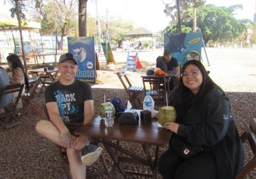 Eduardo and Ceci sitting at a picnic table, smiling.