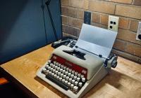 A mid-century typewriter in the chair's office, to go with those mid-century Padelford vibes (to be fair, she does use it!). Mid-century Royal typewriter on a maple and wenge desk.