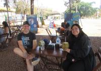 Eduardo and Ceci sitting at a picnic table, smiling.