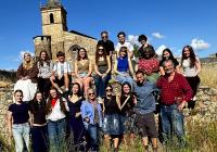 Students in Leon standing in a field and in front of a 14th century monastery.