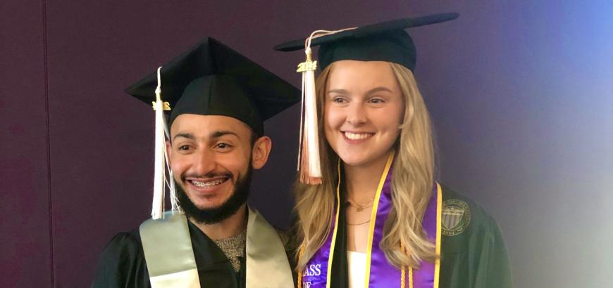 Two of our graduates smiling on graduation day.